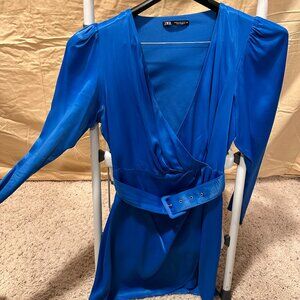 Blue color mini dress with a deep V cleavage and a same material and color belt